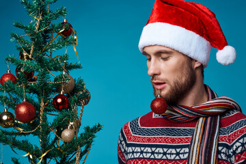 handsome man in New Year's clothes decoration christmas studio posing