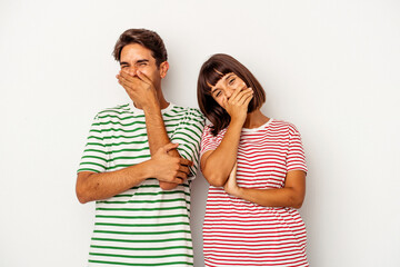 Young mixed race couple isolated on white background laughing happy, carefree, natural emotion.