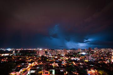 Fototapeta premium Lightning Storm Over Ribeirao Preto City in Brazil. Thunder blue light on a summer night concept image.