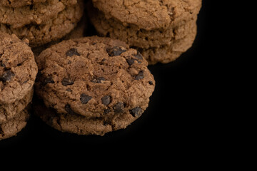 Delicious tasty snack of brown cookies with chocolate chip and peanut isolated on black background