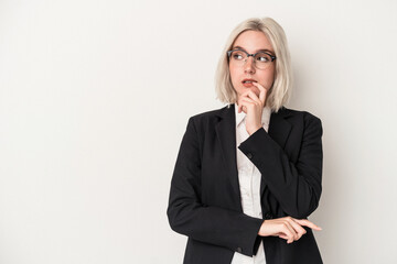 Young caucasian business woman isolated on white background relaxed thinking about something looking at a copy space.