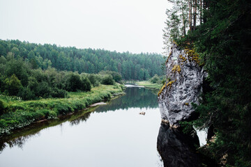Beautiful natural landscape with a rock and a flowing river in the Olenyi Ruchyi park in the Sverdlovsk region