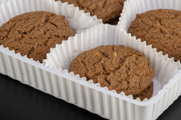 Delicious tasty snack of brown cookies with chocolate chip and peanut isolated on black background