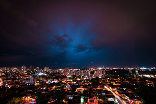 Lightning Storm Over Ribeirao Preto City in Brazil. Thunder blue light on a summer night concept image.