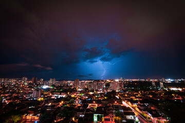 Fototapeta premium Lightning Storm Over Ribeirao Preto City in Brazil. Thunder blue light on a summer night concept image.