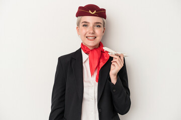 Young air hostess caucasian woman holding plane isolated on white background