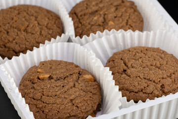 Delicious tasty snack of brown cookies with chocolate chip and peanut isolated on black background