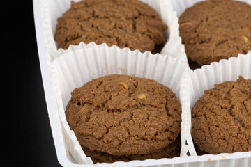 Delicious tasty snack of brown cookies with chocolate chip and peanut isolated on black background