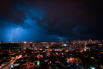 Obraz premium Lightning Storm Over Ribeirao Preto City in Brazil. Thunder blue light on a summer night concept image.
