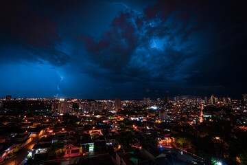 Lightning Storm Over Ribeirao Preto City in Brazil. Thunder blue light on a summer night concept image.