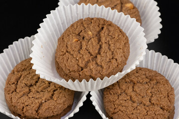 Delicious tasty snack of brown cookies with chocolate chip and peanut isolated on black background