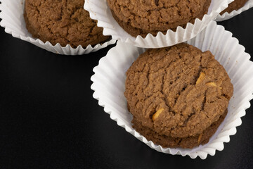 Delicious tasty snack of brown cookies with chocolate chip and peanut isolated on black background