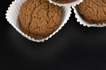 Delicious tasty snack of brown cookies with chocolate chip and peanut isolated on black background