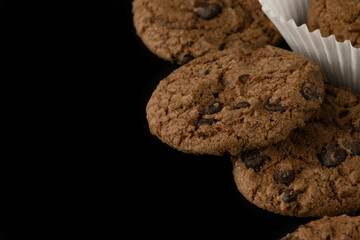 Delicious tasty snack of brown cookies with chocolate chip and peanut isolated on black background