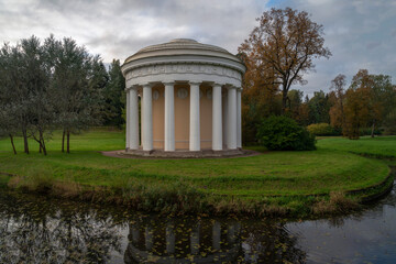 View of the Temple of Friendship on the bank of the Slavyanka River in the Pavlovsky Palace and Park Complex on an autumn cloudy morning, St. Petersburg, Russia