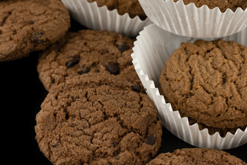 Delicious tasty snack of brown cookies with chocolate chip and peanut isolated on black background