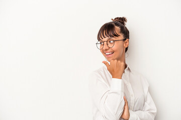 Young mixed race business woman isolated on white background  points with thumb finger away, laughing and carefree.