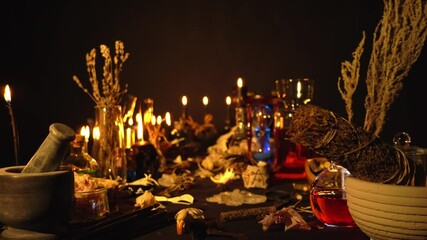 Occult and esoteric witch doctor still life. Halloween background with magic objects. Black candles, skull, crystal stones, and potions vials on witch table. Mystic witchery background with weeds.