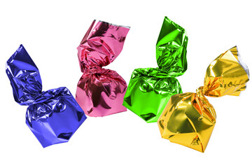 Four chocolate candies in a green, blue, pink and yellow wrapper isolated white background.	
