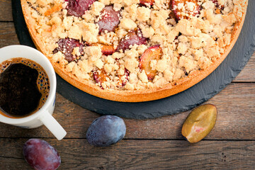 Homemade plum pie and coffee, crumble tart with plum