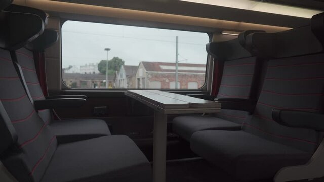Comfortable seat in first class on TGV train first class. French train interior without people. Seats 1 class with table by window. Railway in France. Empty seats in a 1st class TGV wagon in France.