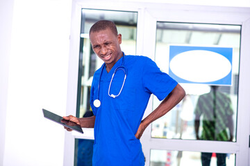 young male doctor suffering from back pain.