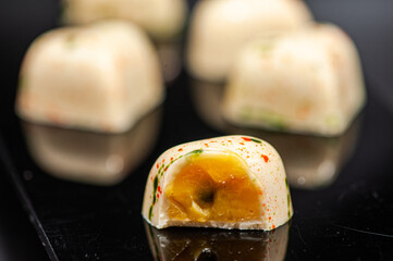 Craft chocolate candies on black background