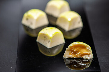 Craft chocolate candies on black background