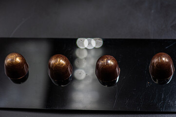 Craft chocolate candies on black background