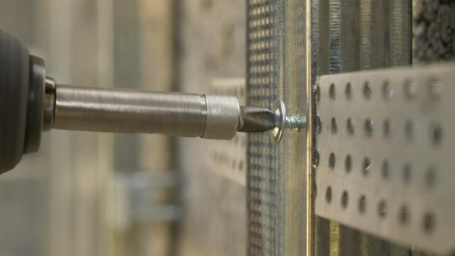 Self tapping screw. Easydrive flange, head flange. Installing metal profile frame on the brick wall.