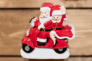 figurines of Santa Claus and Snow Maiden on a motorcycle