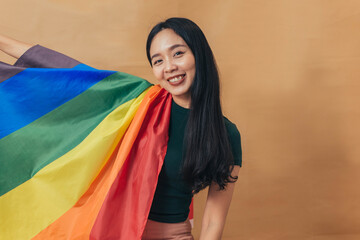 Happy woman smiling and sitting with pride flag. Gender Equality and LGBTQ concept.
