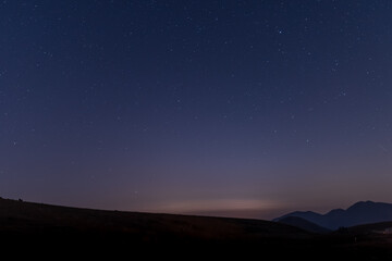 The starry sky at night on the grassland