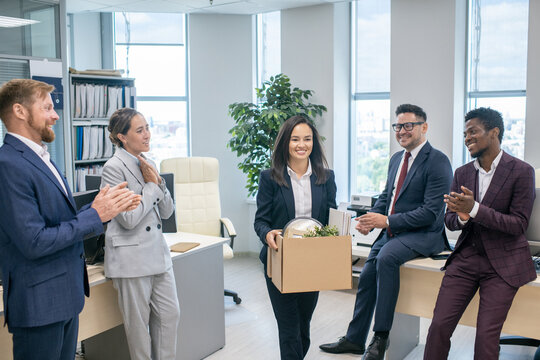 Group of successful business people in formalwear greeting new colleague by clapping hands