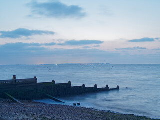 Long Exposure Whitstable Beach at Night Across from Isle of Sheppey Close Pink Sky