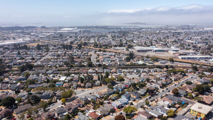 Daytime aerial view of dense residential sprawl in the Bay Area city of Richmond, California, USA.