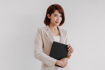 Confident Asian business woman hold a tablet isolated on white background.