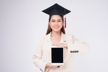 Portrait of young woman graduated over white background.