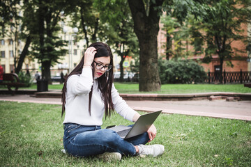 Pretty student using laptop on campus