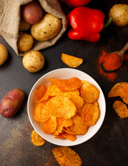 Paprika Potato Chips in white bowl on rustic background