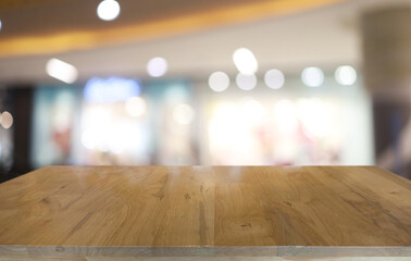 Empty wooden table in front of abstract blurred background of coffee shop . can be used for display or montage your products.Mock up for display of product