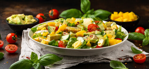 Tasty Chicken mango salad with avocado, cucumber, cherry tomatoes. Healthy food