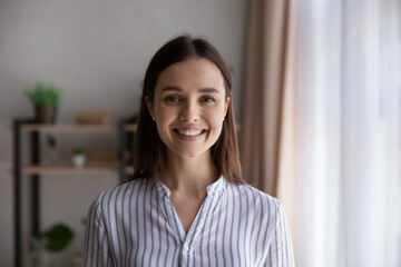 Head shot portrait confident businesswoman, successful entrepreneur, student looking at camera, happy beautiful young woman with healthy toothy smile posing for profile picture, standing at home - obrazy, fototapety, plakaty