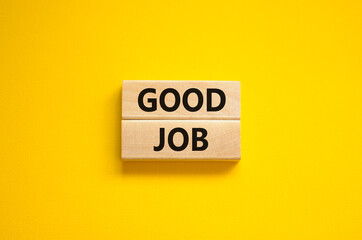 Good job symbol. Concept words 'good job' on wooden blocks on a beautiful yellow background. Business and good job concept, copy space.