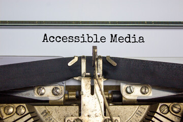 Accessibility and accessible media symbol. Concept words 'Accessible media' typed on old retro typewriter. Diversity, inclusion, belonging and accessible media concept. Copy space.