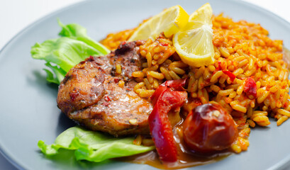 Spicy chicken breast and long grain rice with red peppers, tomatoes and jalapeno chillies