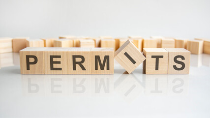 permits text on a wooden blocks, gray background