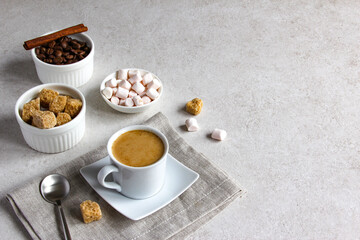 Vanilla coffee with brown sugar and marshmallow. Tasty steam espresso in a cup with coffee beans.