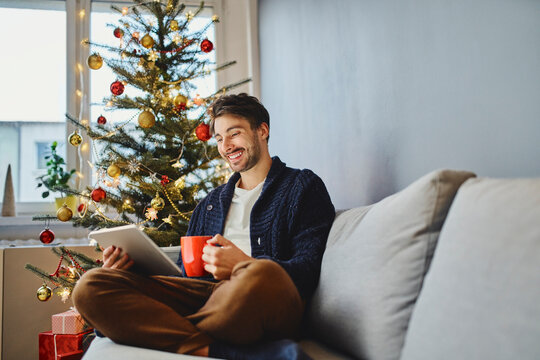 Young man using digital tablet during Christmas video call