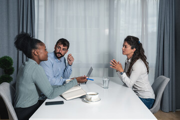 Three young experts business people having a meeting and discussion around the desk in the modern...